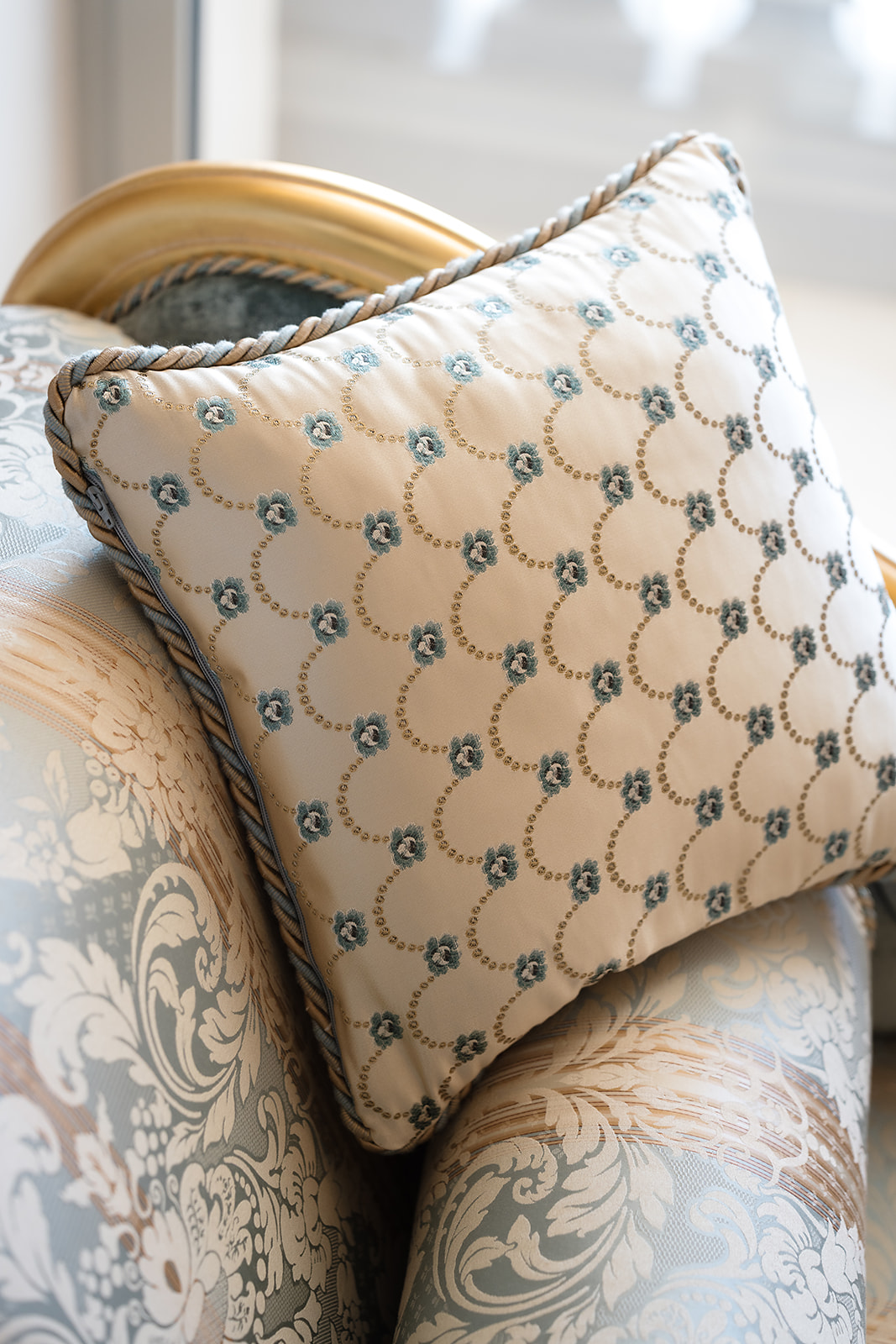 Embroidered silk cushion on a gilded settee