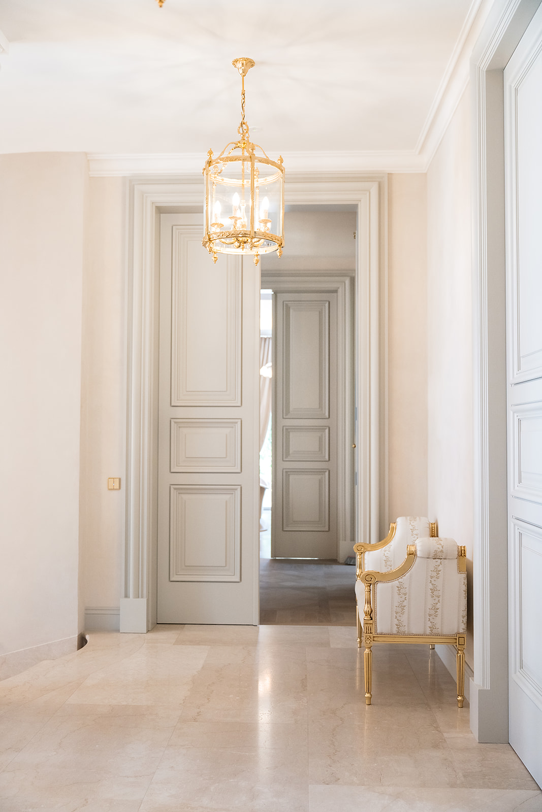 Enfilade of doors lit by a gilt lantern