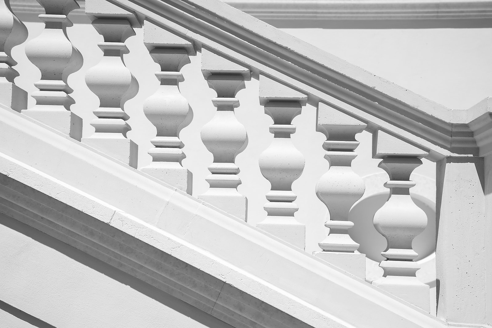 Turned limestone balusters in noon light